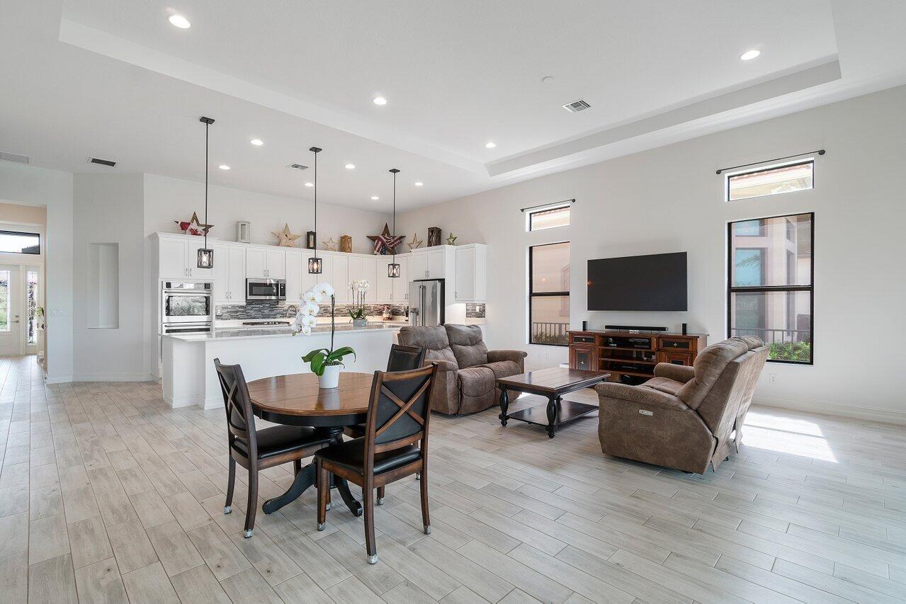 11856 Leon Circle Parkland, FL 33076 - Photo 8 of 43 a living room with furniture and a flat screen tv