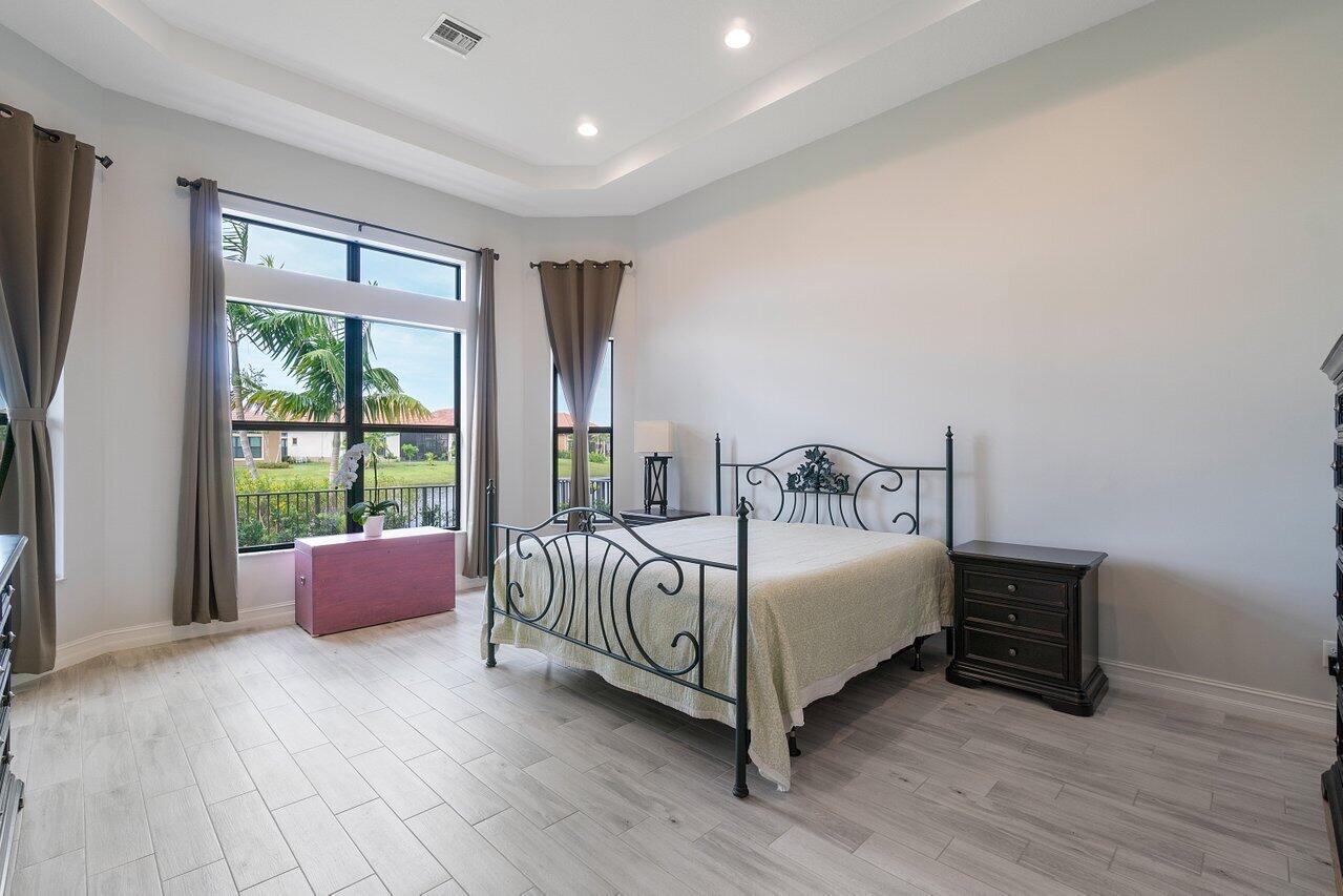 11856 Leon Circle Parkland, FL 33076 - Photo 9 of 43 a bedroom with a bed and a couch