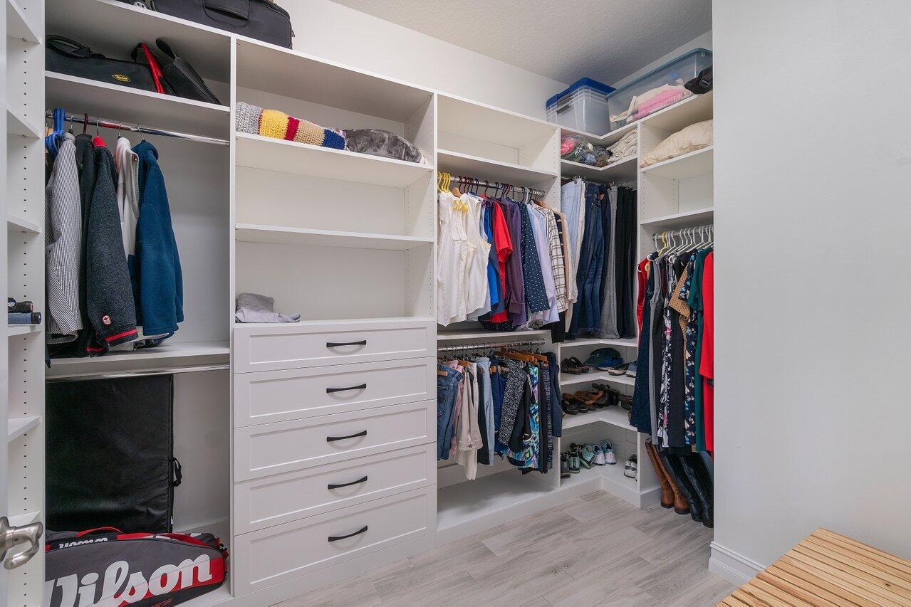 11856 Leon Circle Parkland, FL 33076 - Photo 10 of 43 a view of walk in closet with clothes and shoes