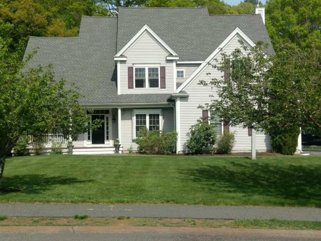 53 Hardwick Road Ashland, MA 01721 - Photo 1 of 18 a front view of a house with a yard