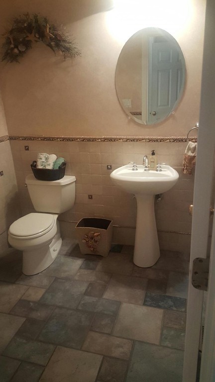 53 Hardwick Road Ashland, MA 01721 - Photo 11 of 18 a bathroom with a toilet sink and mirror