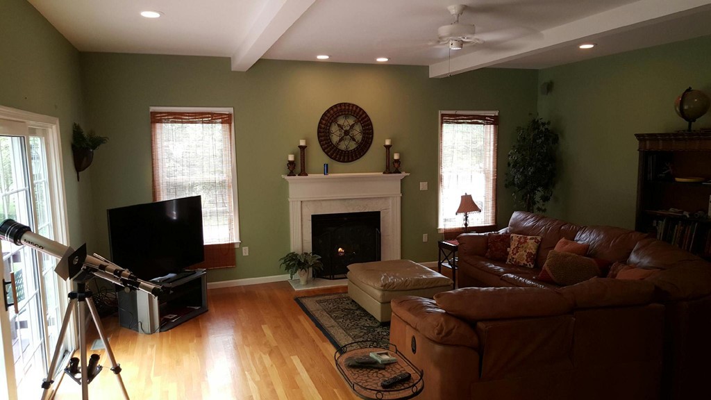 53 Hardwick Road Ashland, MA 01721 - Photo 5 of 18 a living room with furniture a flat screen tv and a fireplace