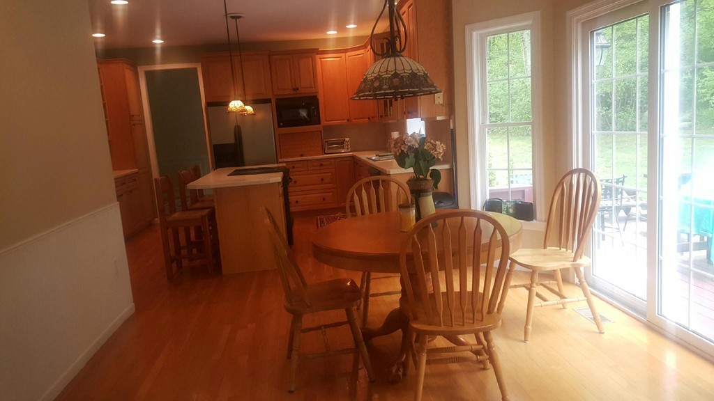 53 Hardwick Road Ashland, MA 01721 - Photo 6 of 18 a view of a dining room with furniture a chandelier and wooden floor
