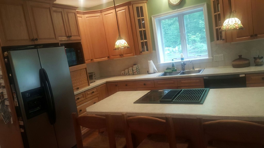 53 Hardwick Road Ashland, MA 01721 - Photo 7 of 18 a kitchen with a sink and a refrigerator