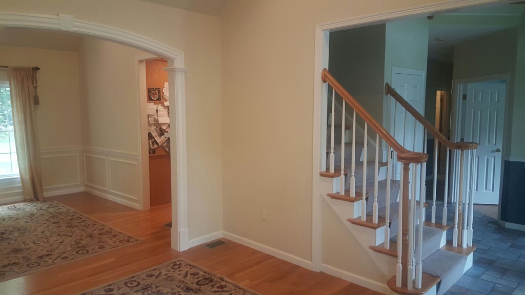 53 Hardwick Road Ashland, MA 01721 - Photo 8 of 18 a view of hallway with wooden floor and stairs