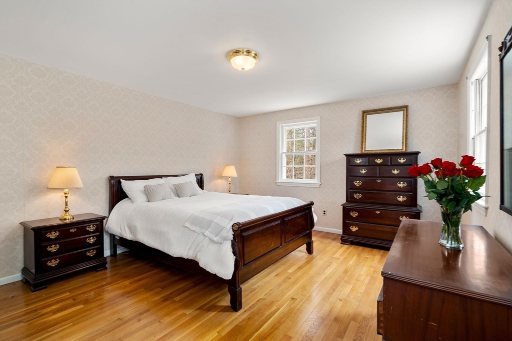 79 Oxbow Road Wayland, MA 01778 - Photo 18 of 30 a spacious bedroom with a bed window and a potted plant