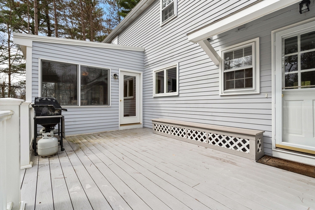 79 Oxbow Road Wayland, MA 01778 - Photo 25 of 30 a view of a wooden deck with a bench