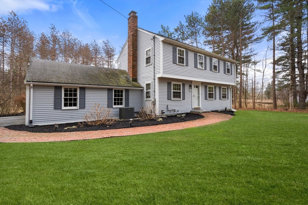 79 Oxbow Road Wayland, MA 01778 - Photo 29 of 30 a front view of a house with a garden