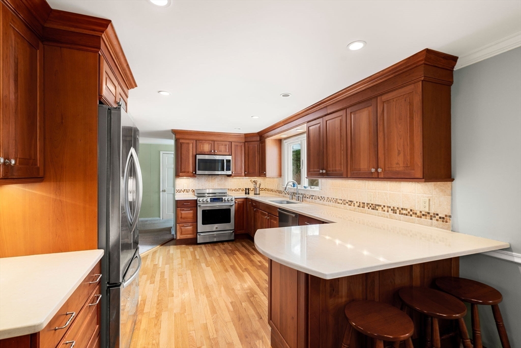 79 Oxbow Road Wayland, MA 01778 - Photo 8 of 30 a kitchen with a sink refrigerator and cabinets