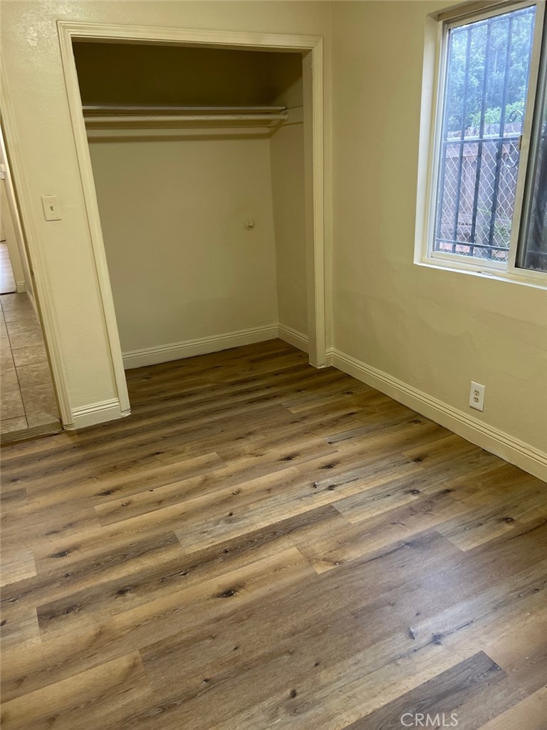 10529 Grape Street Los Angeles, CA 90002 - Photo 12 of 12 a view of an empty room with wooden floor and a window