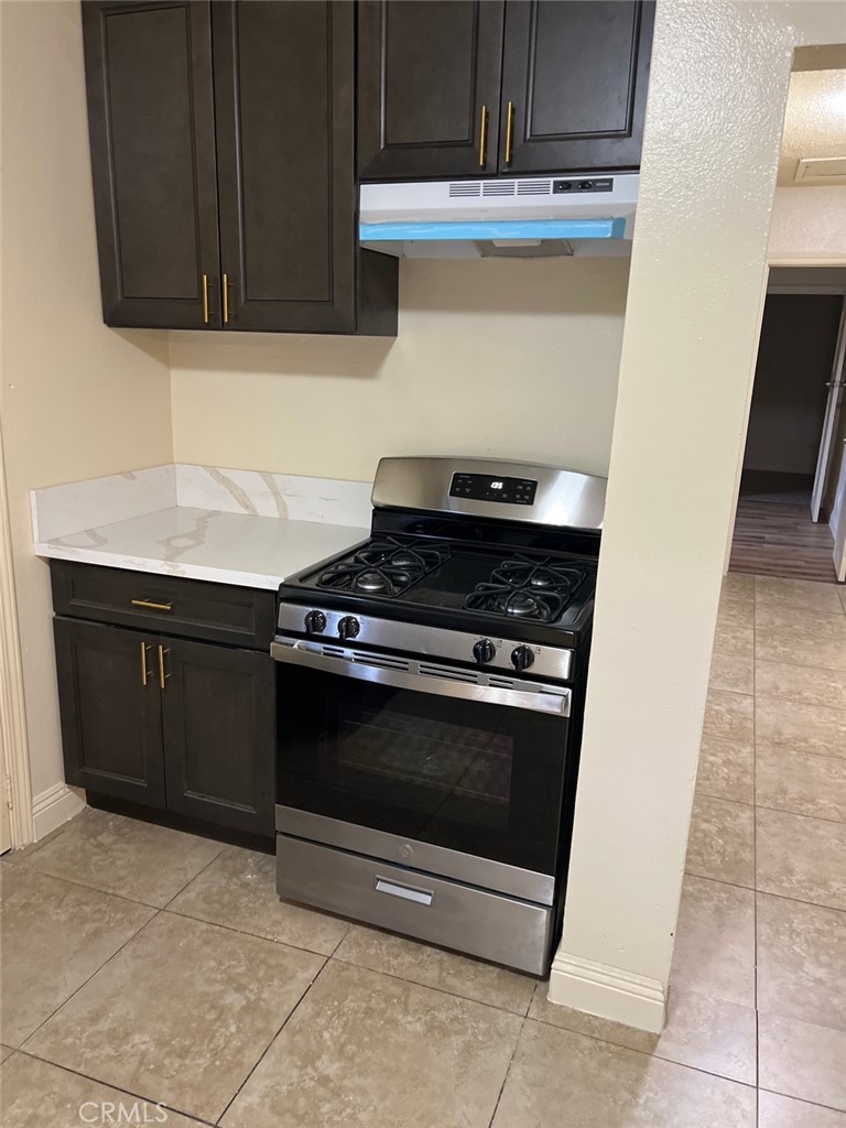 10529 Grape Street Los Angeles, CA 90002 - Photo 4 of 12 a stove top oven sitting inside of a kitchen