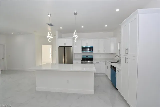 a view of entryway with kitchen and living room