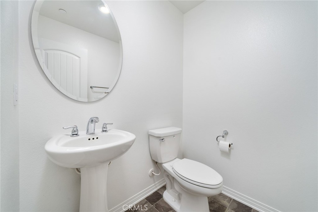 16502 Casa Grande Avenue, Unit 102 Fontana, CA 92336 - Photo 12 of 41 a bathroom with a sink toilet and a mirror