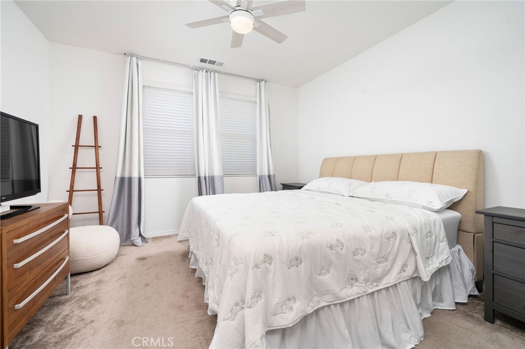 16502 Casa Grande Avenue, Unit 102 Fontana, CA 92336 - Photo 18 of 41 a bedroom with a bed and flat screen tv