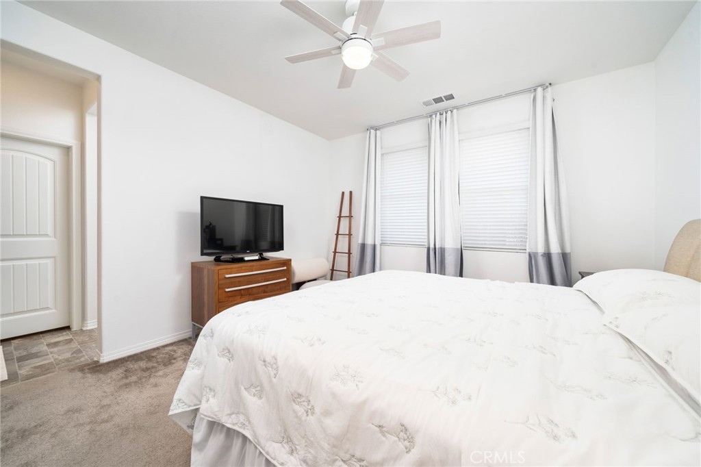 16502 Casa Grande Avenue, Unit 102 Fontana, CA 92336 - Photo 19 of 41 a bedroom with a bed and a flat screen tv