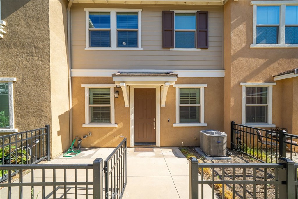 16502 Casa Grande Avenue, Unit 102 Fontana, CA 92336 - Photo 2 of 41 a view of house with a chairs and table in a patio