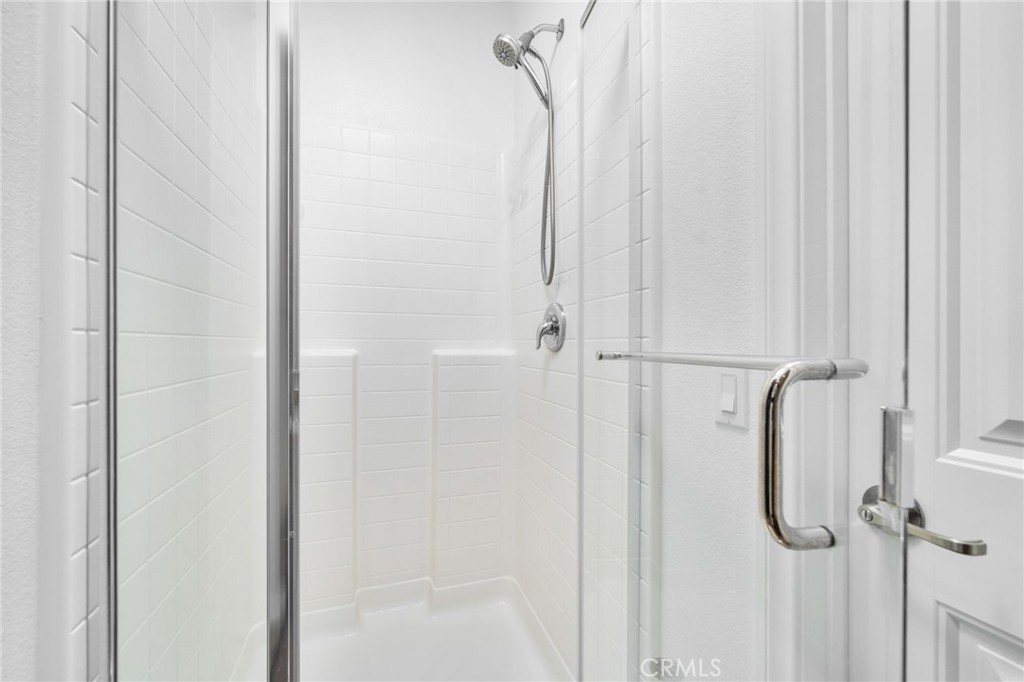 16502 Casa Grande Avenue, Unit 102 Fontana, CA 92336 - Photo 21 of 41 a bathroom with a glass shower door