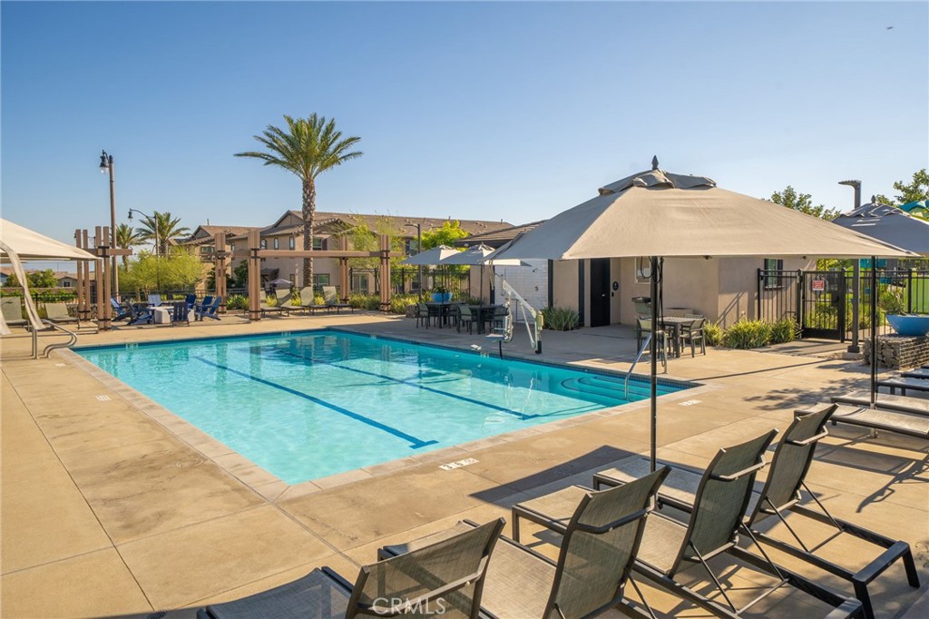 16502 Casa Grande Avenue, Unit 102 Fontana, CA 92336 - Photo 38 of 41 a swimming pool with outdoor seating and yard