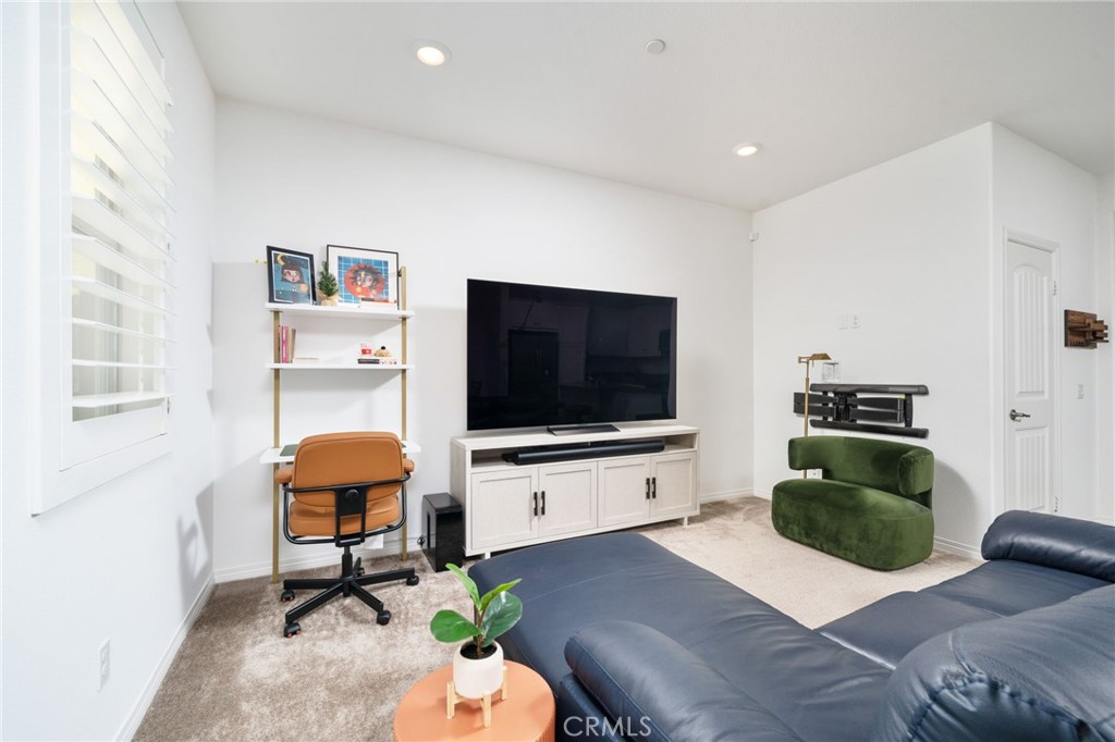 16502 Casa Grande Avenue, Unit 102 Fontana, CA 92336 - Photo 4 of 41 a living room with furniture and a flat screen tv
