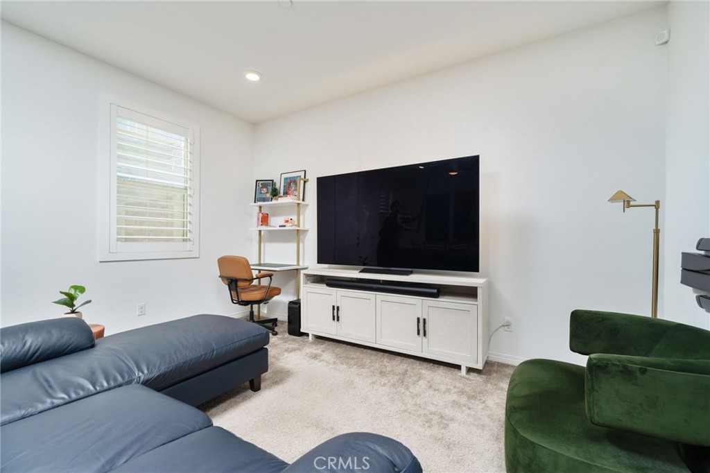 16502 Casa Grande Avenue, Unit 102 Fontana, CA 92336 - Photo 6 of 41 a living room with furniture and a flat screen tv
