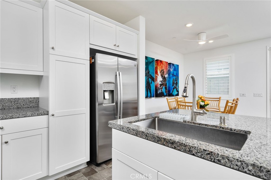 16502 Casa Grande Avenue, Unit 102 Fontana, CA 92336 - Photo 10 of 41 a kitchen with stainless steel appliances granite countertop a refrigerator a stove and a sink with wooden floors