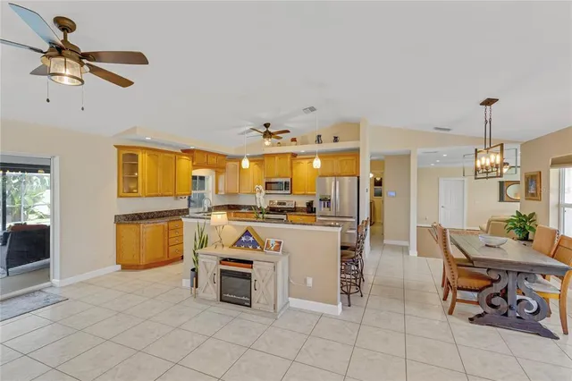 a kitchen with stainless steel appliances granite countertop a sink a stove and a refrigerator