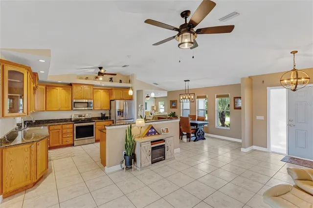 a kitchen with granite countertop a sink and cabinets