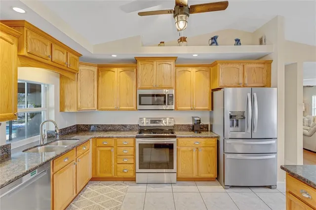 a view of a dining room and livingroom with furniture wooden floor a chandelier