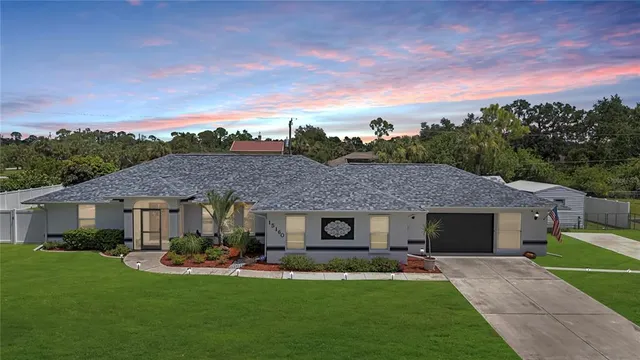 a front view of a house with a garden and plants