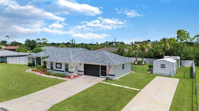 an aerial view of a house with swimming pool garden and patio