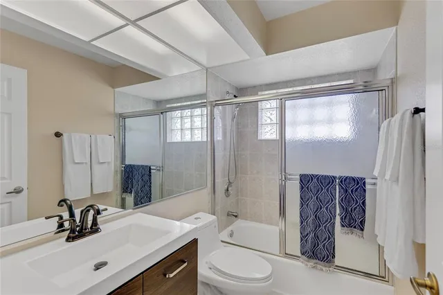 a living room with patio furniture and a potted plants