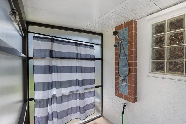 a view of a backyard with a patio and a table and chairs