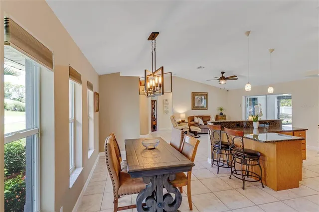 a kitchen with stainless steel appliances kitchen island granite countertop a stove and cabinets