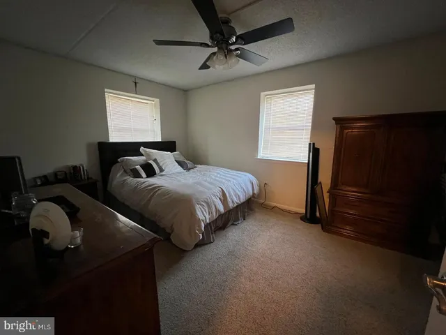 a bedroom with bed and window