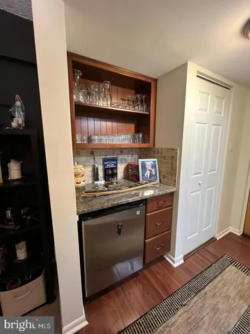 a kitchen with stainless steel appliances granite countertop a refrigerator and a stove