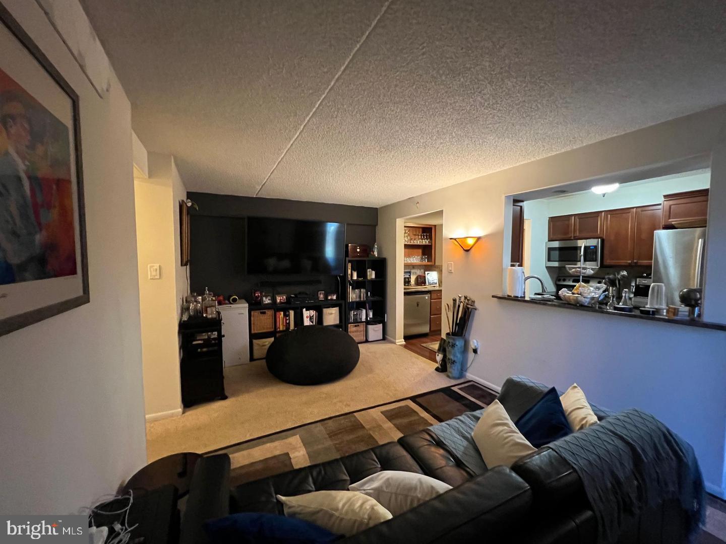 3304 Valley Drive, Unit 3304 West Chester, PA 19382 - Photo 9 of 18 a living room with furniture and a flat screen tv