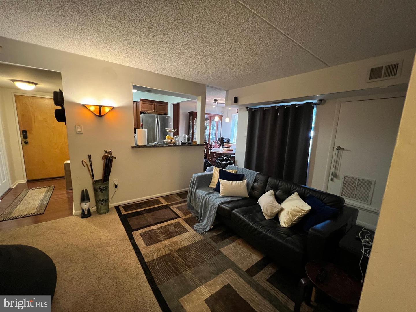 3304 Valley Drive, Unit 3304 West Chester, PA 19382 - Photo 10 of 18 a living room with furniture and a flat screen tv