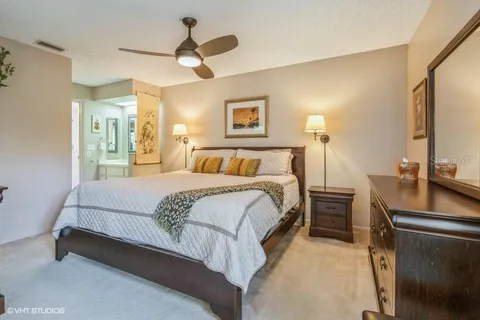 a bedroom with a bed and a desk