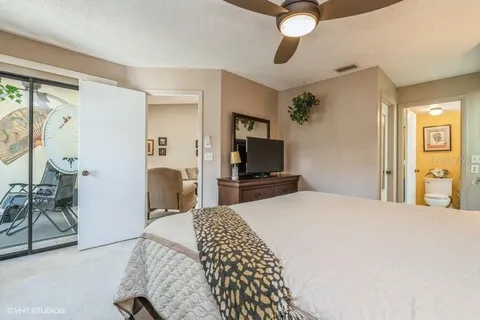 a bedroom with a bed and a television