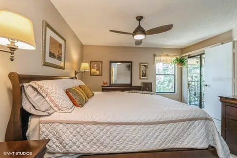 a bedroom with a large bed and a chandelier