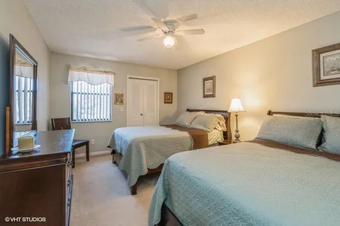 a bedroom with two beds and a chandelier