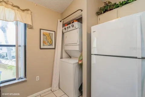 a white refrigerator freezer sitting inside of a kitchen