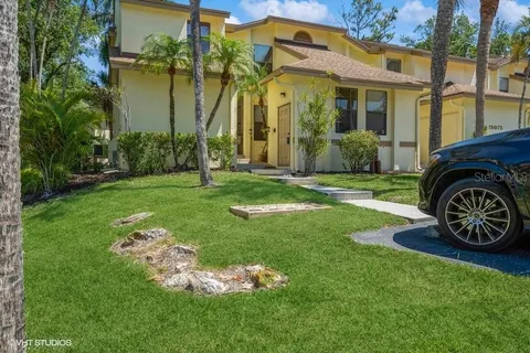 a view of a car parked in front of a brick house