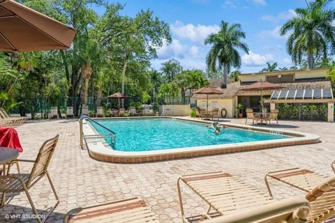 a view of a backyard with swimming pool