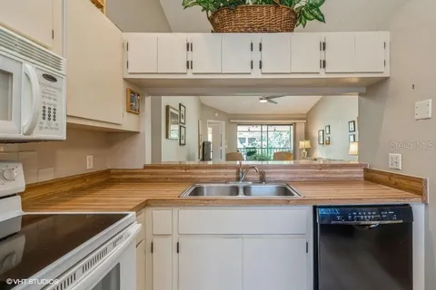 a kitchen with stainless steel appliances granite countertop a sink and cabinets