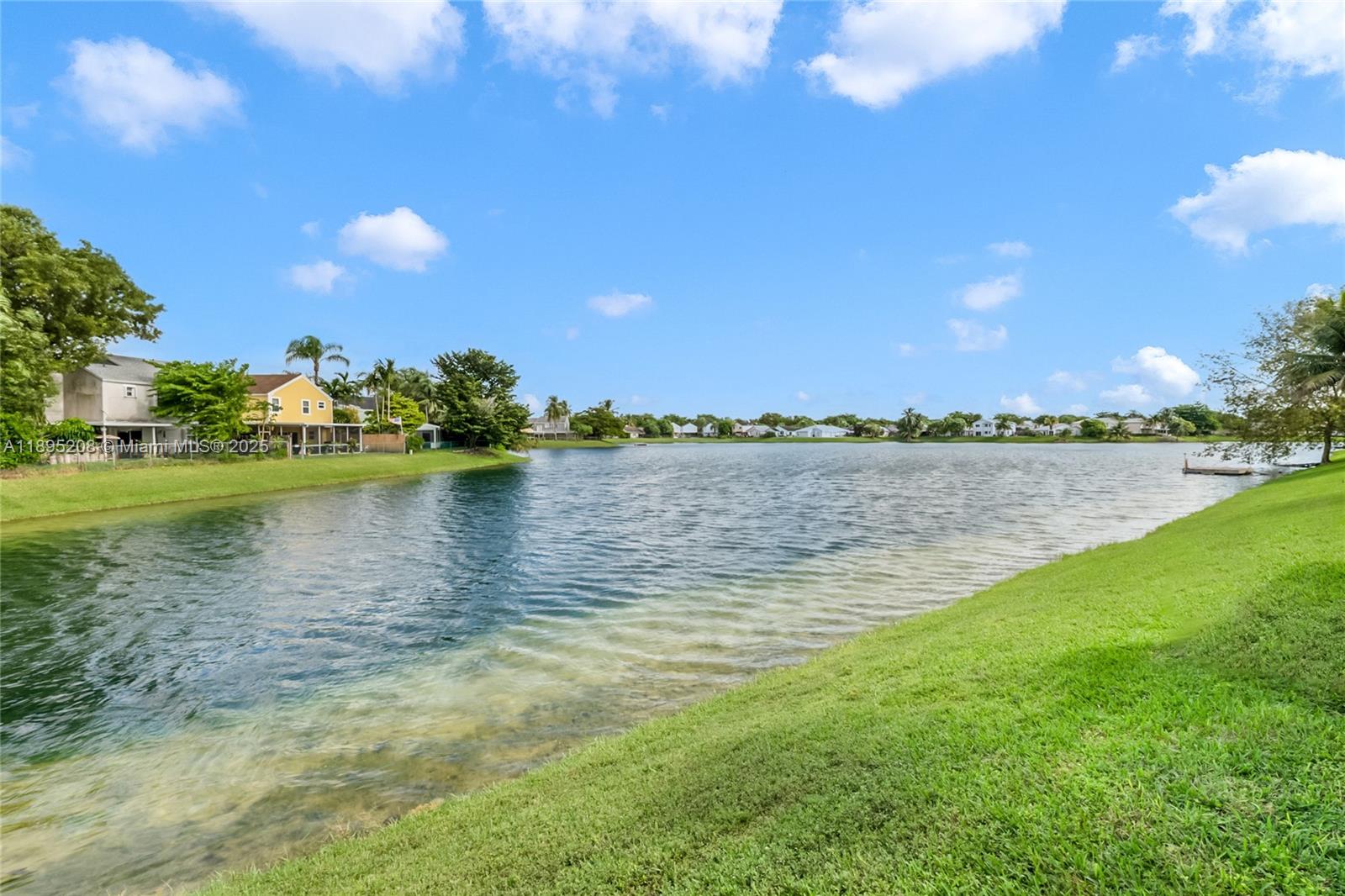 12525 Southwest 147th Terrace Miami, FL 33186 - Photo 15 of 15 a view of a lake with houses in the background
