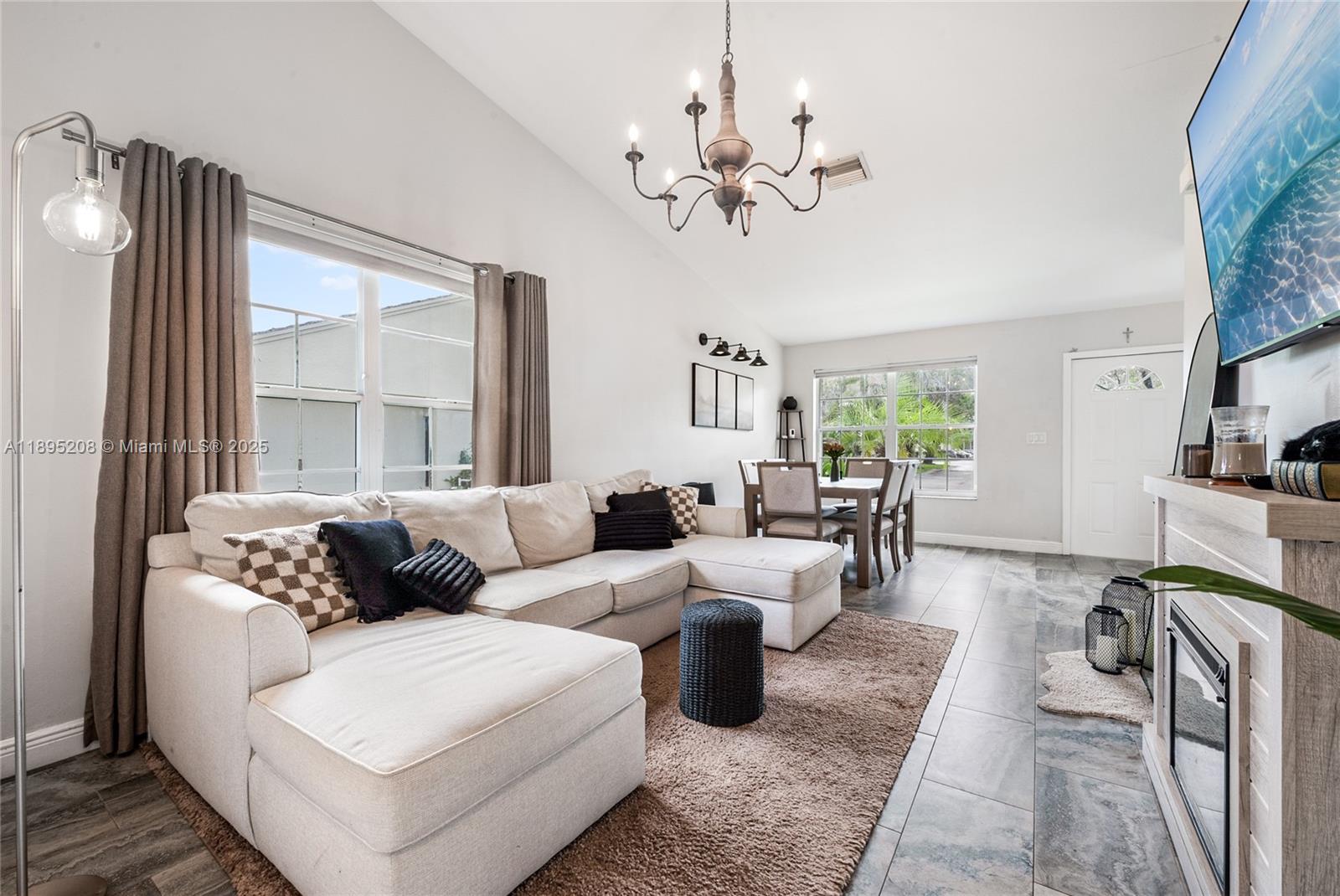 12525 Southwest 147th Terrace Miami, FL 33186 - Photo 2 of 15 a living room with furniture and a large window