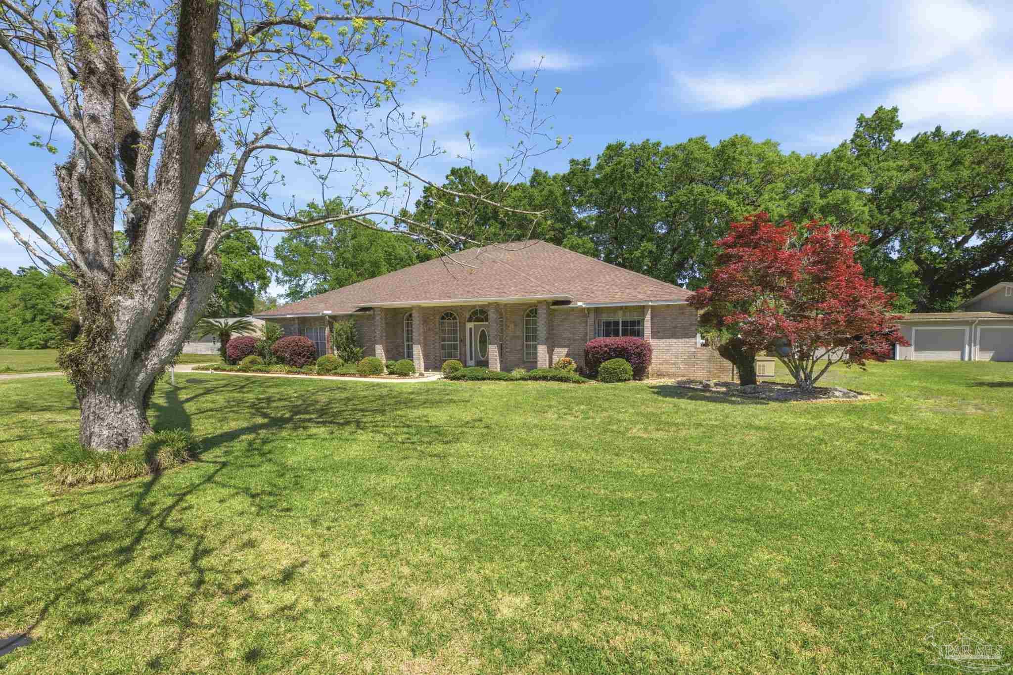 4552 Peaden Road Pace, FL 32571 - Photo 3 of 38 a front view of a house with garden