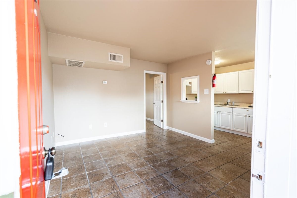 a view of a kitchen with a refrigerator cabinets and a window