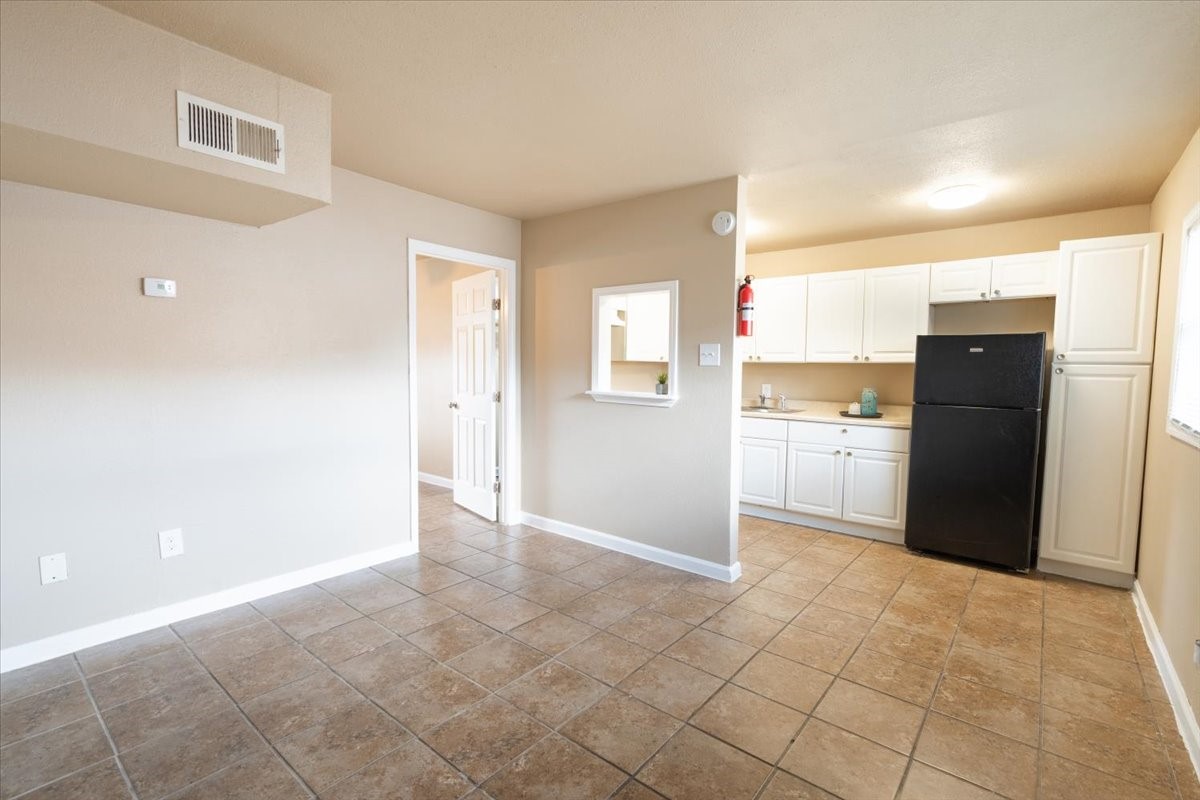 1907 Dismuke Street, Unit 35 Houston, TX 77023 - Photo 2 of 8 a view of a kitchen with refrigerator and cabinet